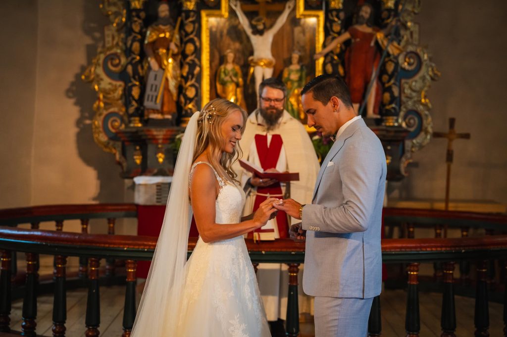 Bruden ger brudgummen vigselringen i Mikaelikyrkan i Arvika.