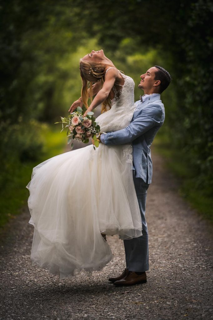 Bröllopsporträtt av brudparet i allén på Viksholmen i Arvika.