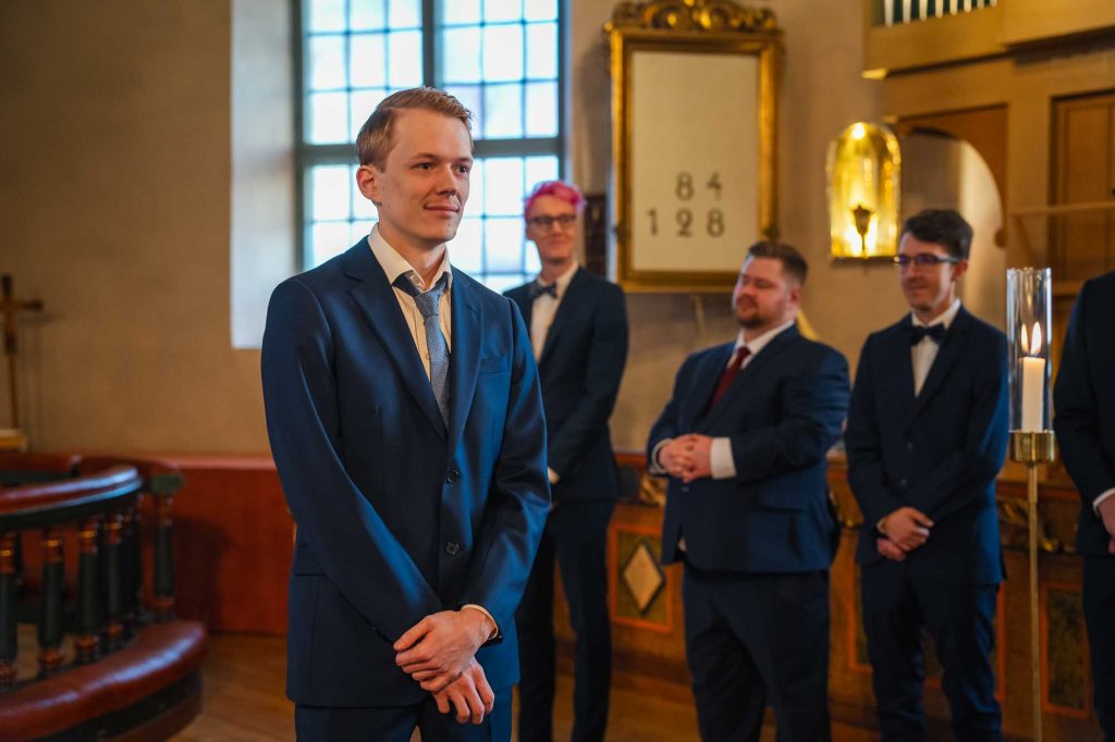 Brudgummen väntar på bruden i Mikaelikyrkan i Arvika.