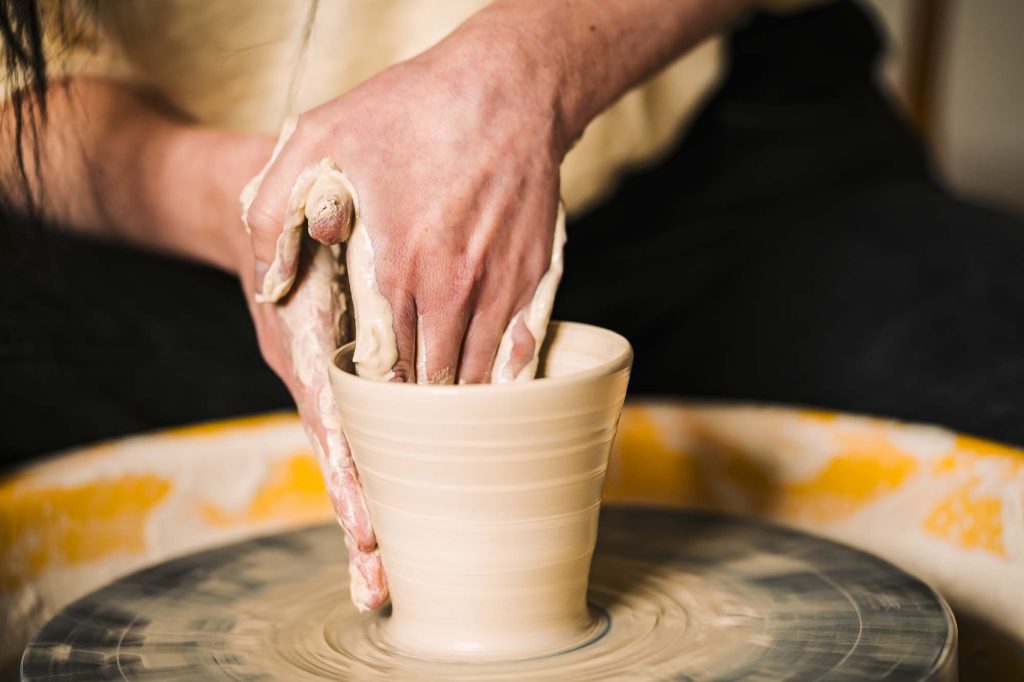 Bild av Julias händer som drejar en kopp på Julias hörna i Jössefors Folkets hus.