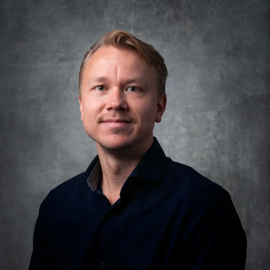 Företagsporträtt av en man med mustasch i mörkblå skjorta, tagit i Värmland av Pixpep